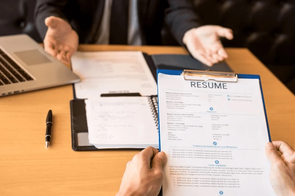 Job Candidate Showing His Resume To The Recruiter