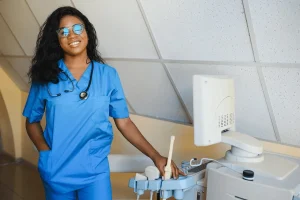 nurse practitioner beside a medical equipment