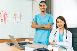 Physician Assistant Working Alongside A Physician In A Clinical Setting
