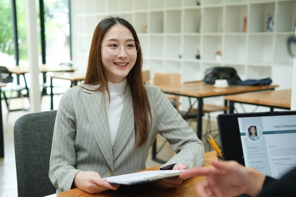 Recruiter Holding The Resume Of An Entry-Level Job Applicant