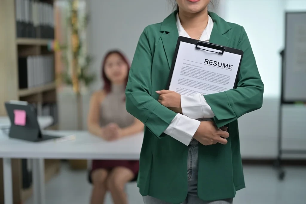 Confident Job Applicant Standing While Holding Her Resume