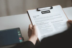 Employer Evaluating Applicant By Reviewing Job Responsibilities In Resume
