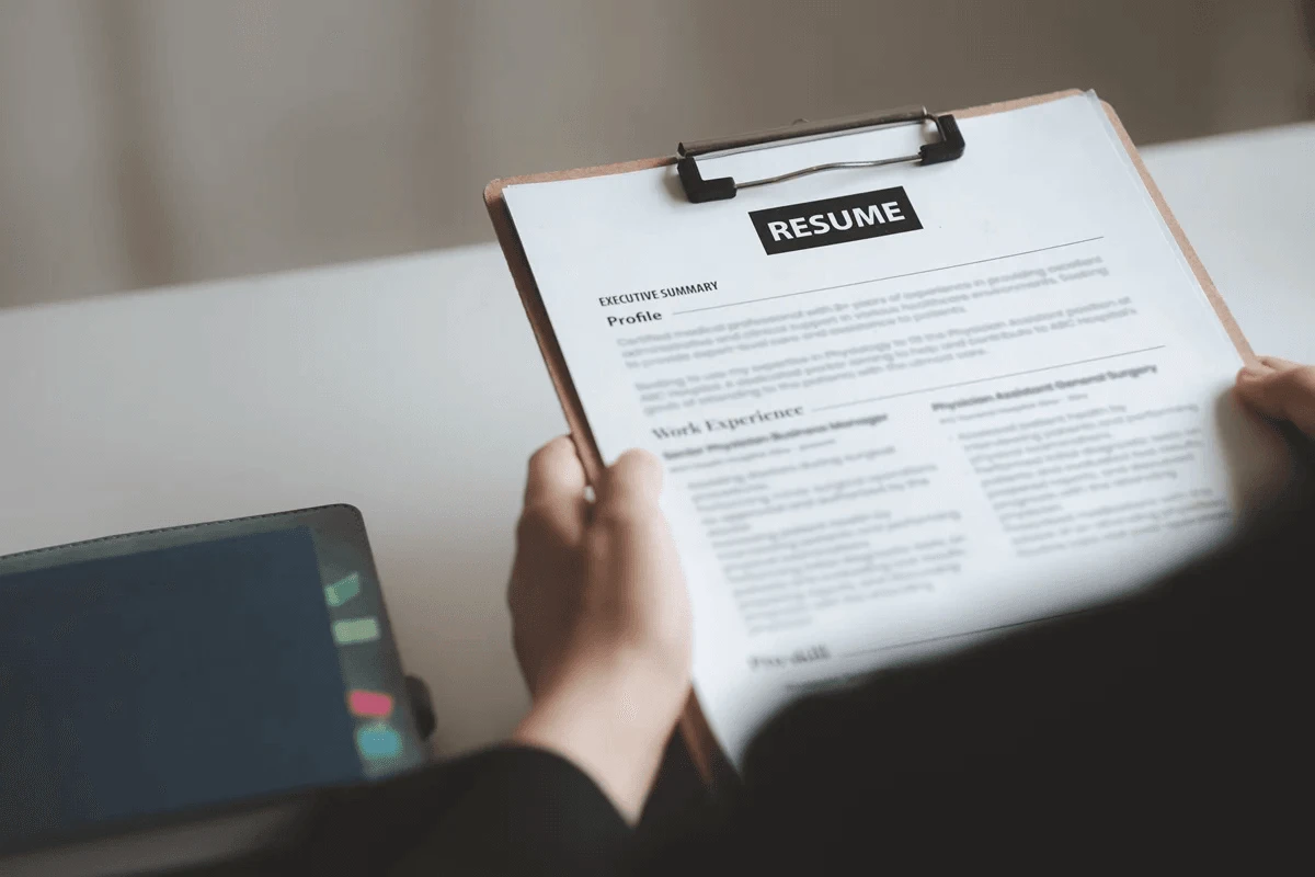 employer evaluating applicant by reviewing job responsibilities in resume