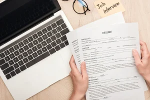 Resume And Laptop Used By A Job Applicant