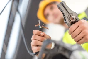 worker using electrician skills to fix wiring