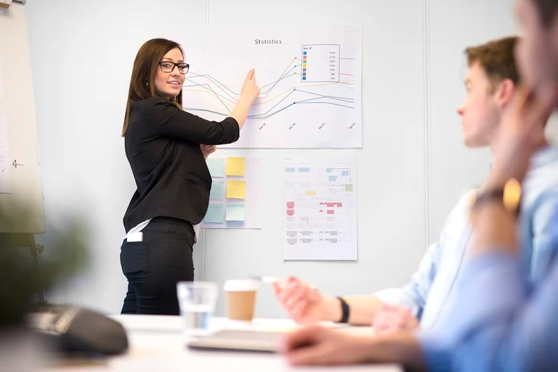 Financial Analyst Reviewing Compliance Reports And Regulatory Documents To Manage Risks