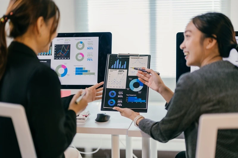 Team Using Data Management Skills To Interpret Analytics And Drive Business Decisions
