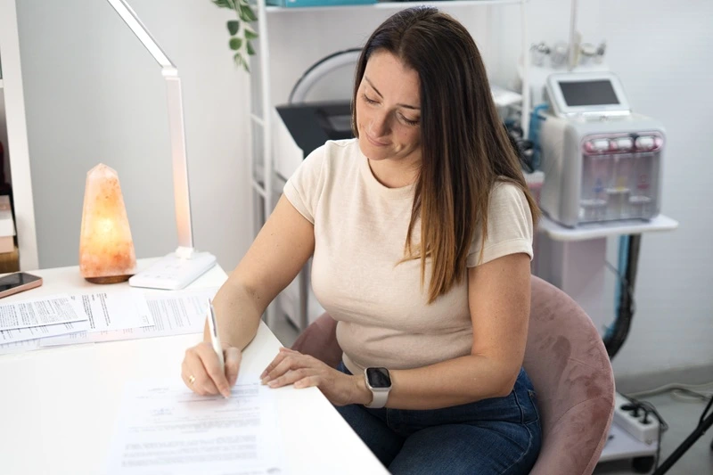 Woman Writing Resume Based On Resume Guide Best Practices