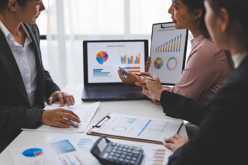 Financial Professionals Analyzing Charts Showcasing Key Skills For Financial Analyst