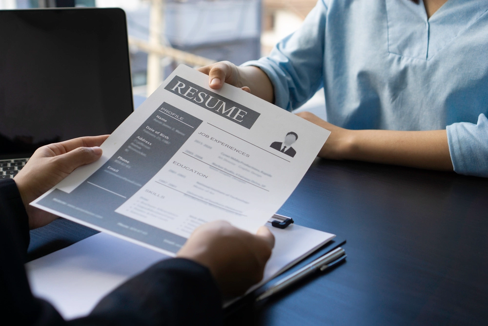 An Applicant Submitting A Resume Showcasing Skills And Experience Using Good Adjectives