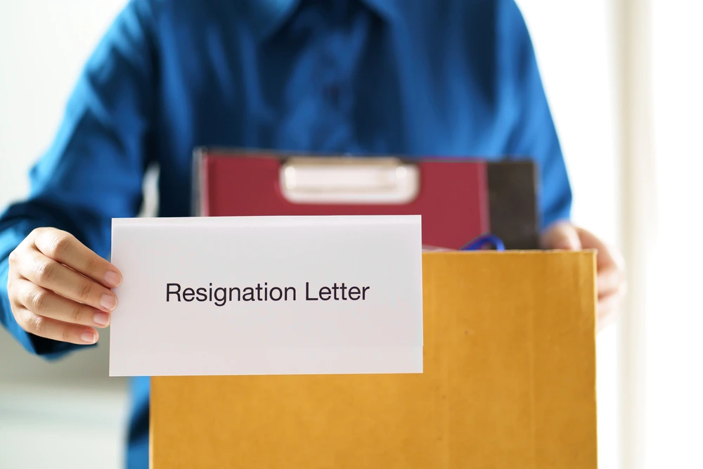 A Man Holding A Resignation Letter