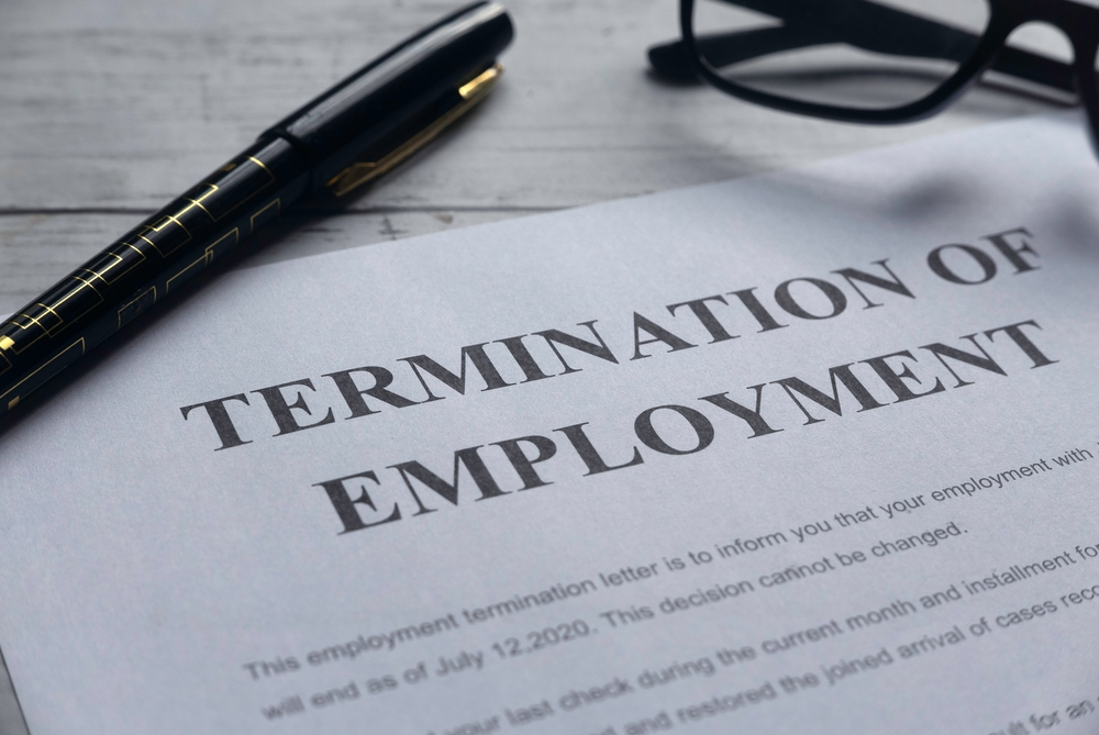A Pen And A Termination Of Employment Document Drafted In Line With Voluntary Separation Scheme