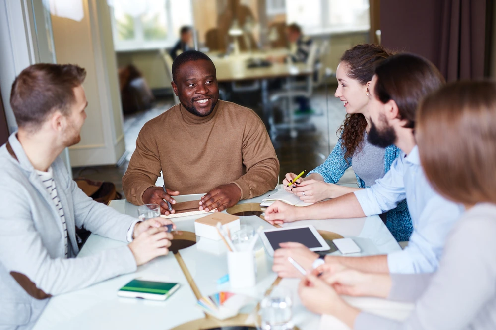 A Leader Holding A Meeting, Depicting The Difference Of Leadership Influence Between Supervisor Vs Manager