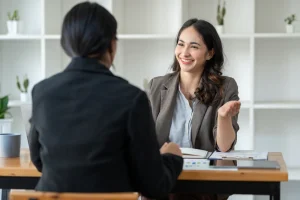 A job applicant enthusiastically sharing her fun facts examples during the interview.
