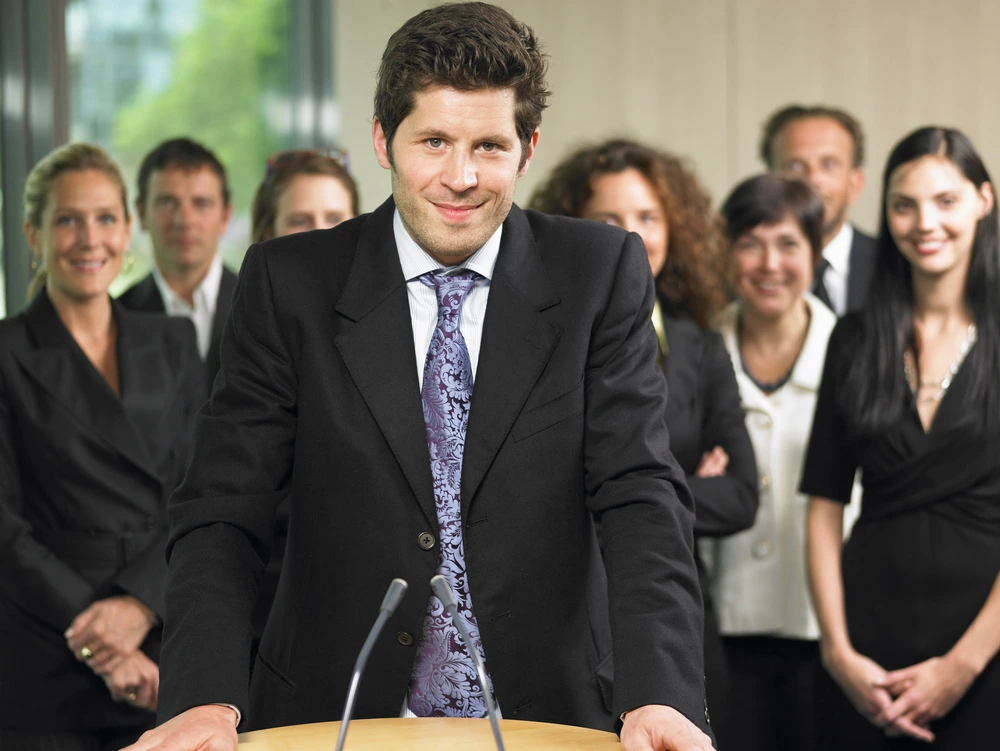 A Man Speaking At A Conference