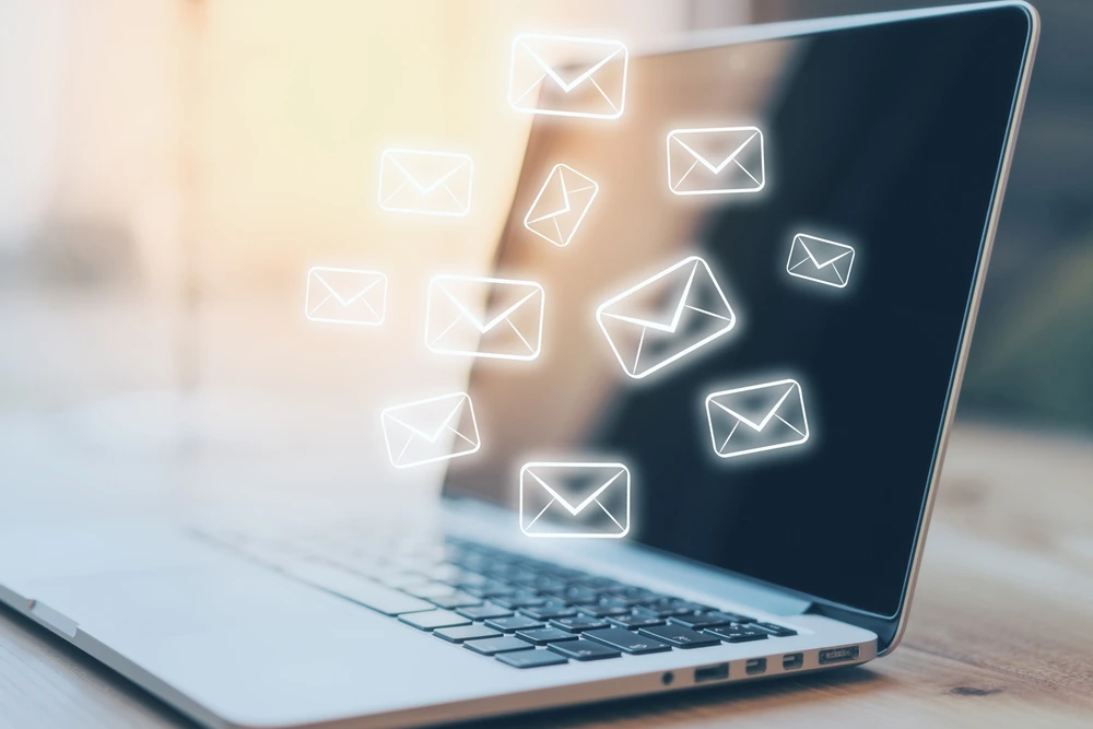 A Side View Of A Laptop With Email Sketches