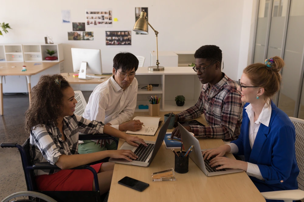 A Group Of College Students Brainstorming During A Hackathon, Illustrating Teamwork And Creativity While Exploring What Is A Hackathon All About.
