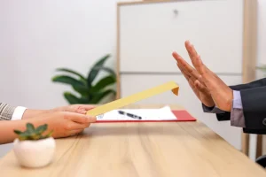 A Pair Of Hands Rejecting A Job Offer
