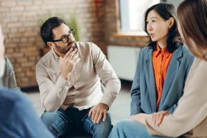 A Group Of Professionals Showing Empathetic Listening During Huddles.