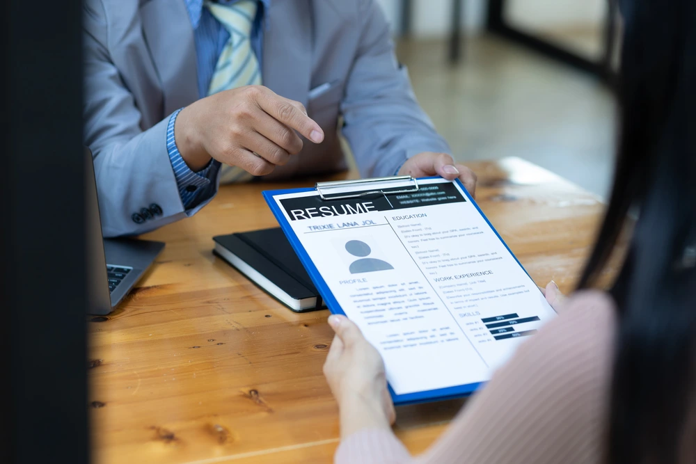 A Hiring Manager Pointing Out Mistakes In An Applicant Resume Profile