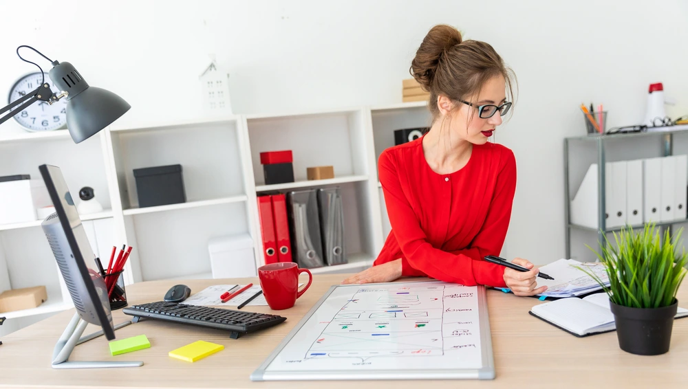 An Employee Organizing Calendars And Schedules For Executives, Demonstrating Execution Of Administrative Assistant Duties.
