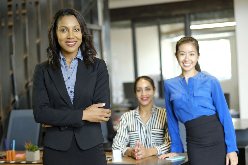 A Portrait Of Administrative Assistants In An Office Setting.