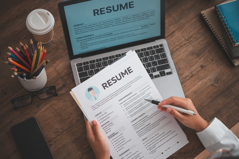 A High Angle Shot Of A Job Applicant Deciding On The Best Resume Format To Use.