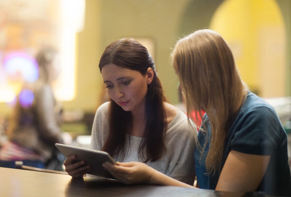 A Lady Guiding Her Colleague Read Scores From The Ats Resume Checker